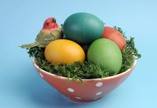 Happy Easter still life with colorful eggs on blue background. — Stock Photo, Image