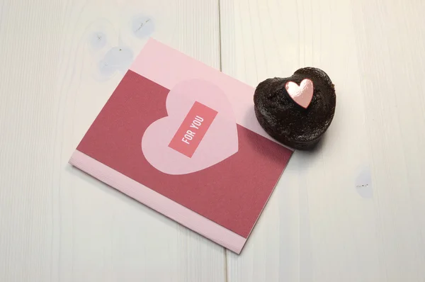 Love theme handmade gift card with For You greeting and mini chocolate muffin cup cake treat on shabby chic table. — Stock Photo, Image