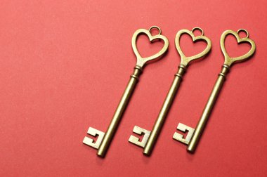 Three 3 gold keys on red background. clipart