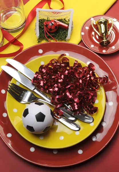 Soccer football celebration party table settings in red and yellow team colors. Vertical portrait orientation, — Stock Photo, Image