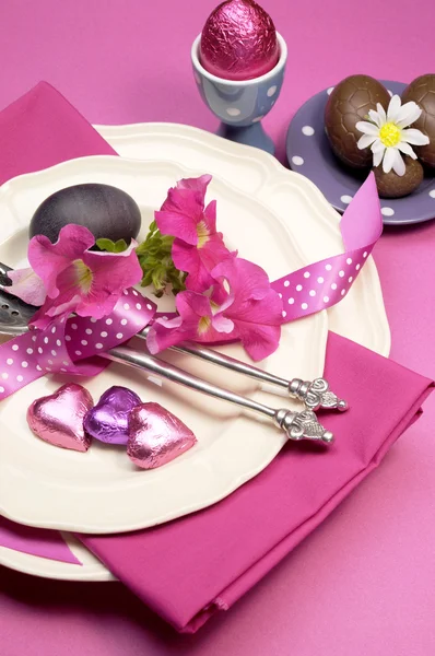Decorative Happy Easter dinner table setting with boiled and chocolate Easter eggs. Vertical orientation. Stock Picture