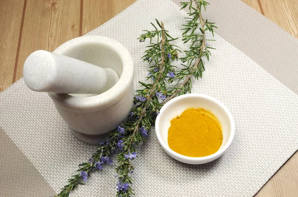 Rosemary herb and turmeric spice with mortar and pestle — Stock Photo, Image