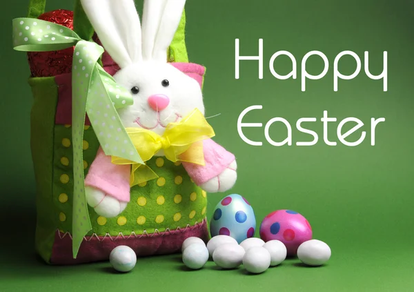 Happy Easter message with Bunny basket and eggs for Easter Sunday egg hunt. Stock Photo