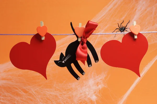 Happy Halloween message written across red hearts and black cat — Stock Photo, Image