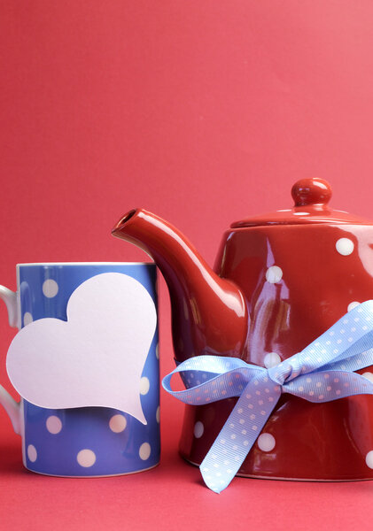 Red, white and blue breakfast with polka dot tea pot, cup mug, and egg in egg cup against a red background for a patriotic breakfas