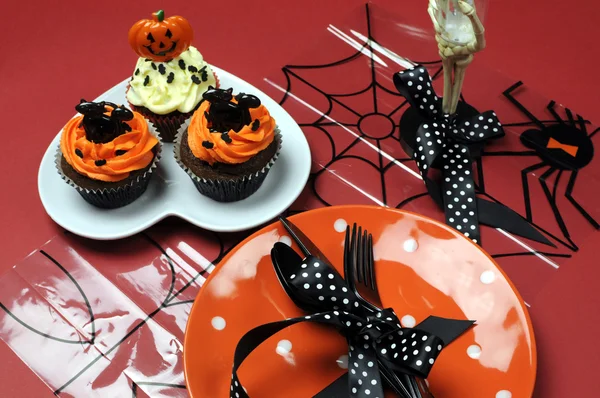 Feliz mesa de fiesta de Halloween con plato de lunares naranja y cupcakes de chocolate — Foto de Stock