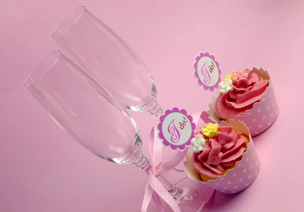 Pink wedding cupcakes with I Do topper signs - with champagne glasses and polka dot ribbon. — Stock Photo, Image