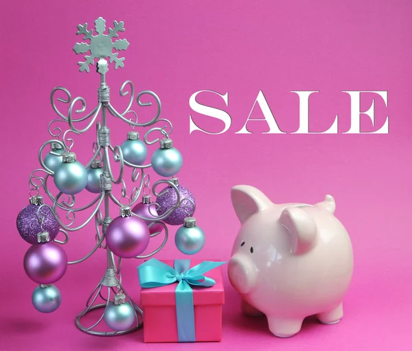 Christmas Sale still life with pastel pink and blue, with silver Christmas Tree and baubles with gift and piggy bank — Stock Photo, Image