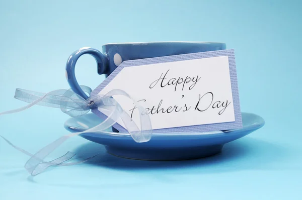Happy Fathers Day gift of a cup of coffee or tea in a blue polka dot cup and saucer — Stock Photo, Image