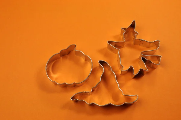 Happy Halloween cookie shapes on orange background — Stock Photo, Image