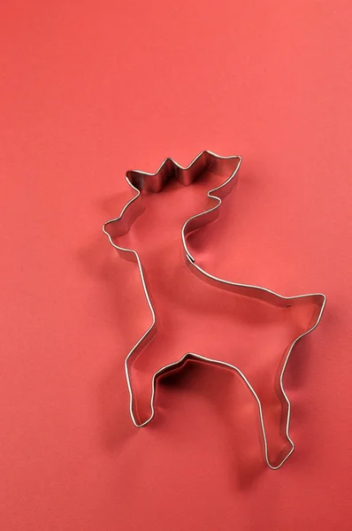 Christmas cookie cutter shapes on red background — Stock Photo, Image