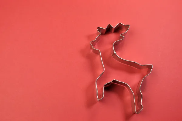 Christmas cookie cutter shapes on red background — Stock Photo, Image
