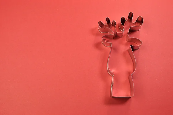 Christmas cookie cutter shapes on red background — Stock Photo, Image