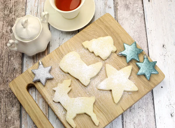 Christmas shapes shortbread cookies with cup of tea — Stock Photo, Image