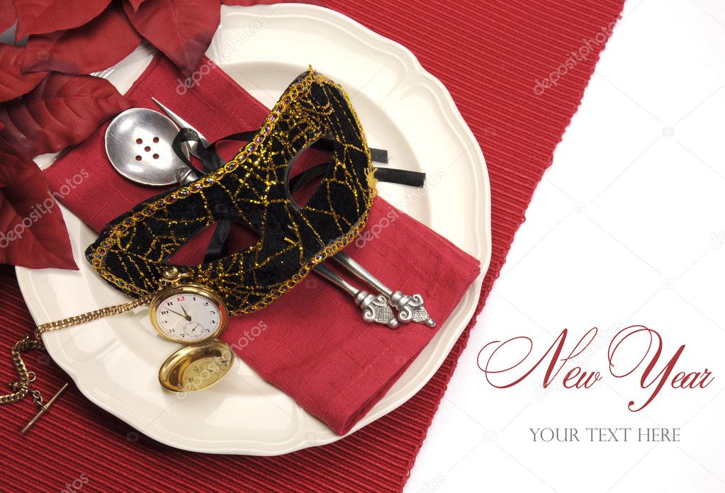 New Years Eve dining table place setting with masquerade mask