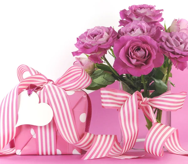 Belas rosas de presente rosa no fundo rosa e branco — Fotografia de Stock