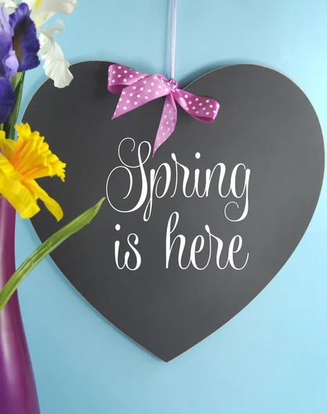 Spring Is Here greeting on heart shape blackboard — Stock Photo, Image