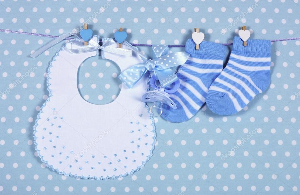 Baby boy nursery blue socks and bib, with dummy pacifier hanging