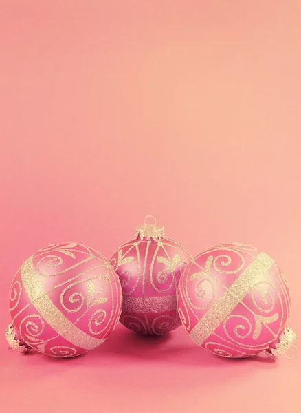 Beautiful fuchsia pink festive bauble ornaments on a feminine pi — Stock Photo, Image