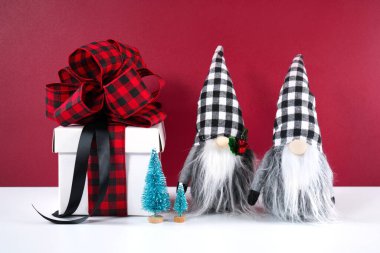 Christmas farmhouse black red and white plaid check gnomes and gift. clipart