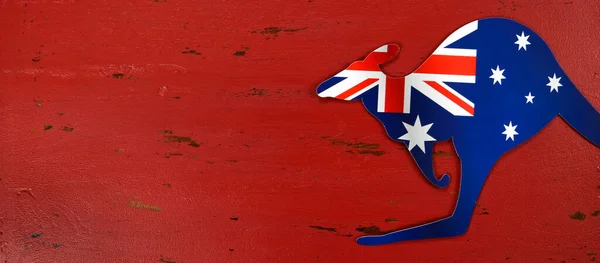 Kangaroo shape Australian flag on red rustic recycled wood background banner. Stockbild