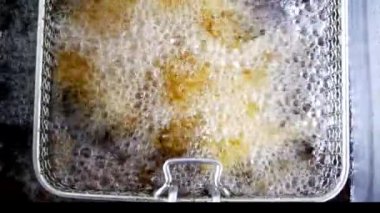 Top view, Oil is boiling while frying. Heat oil in a stove over high heat.