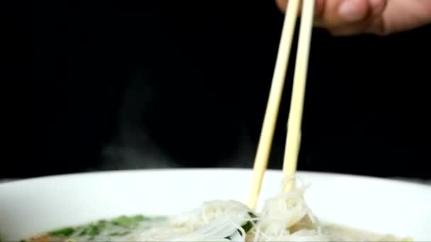 Noodles Bowl Hot Chopsticks Heat Emanated Noodles Black Background — стоковое видео
