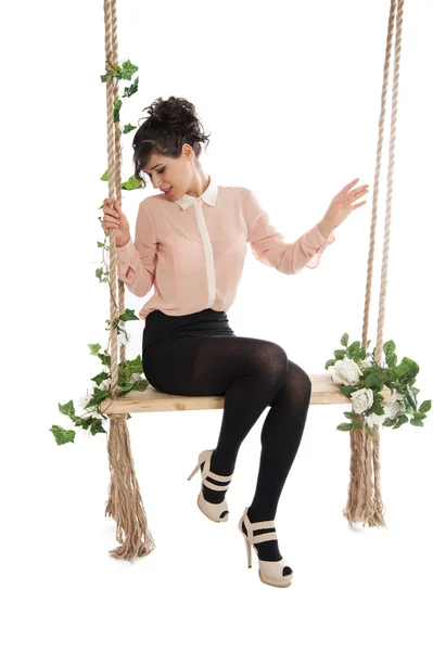 A woman is sitting on a swing — Stock Photo, Image