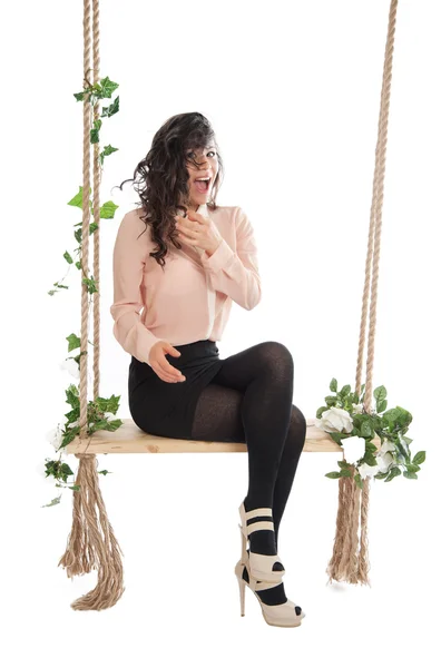 A woman is sitting on a swing — Stock Photo, Image