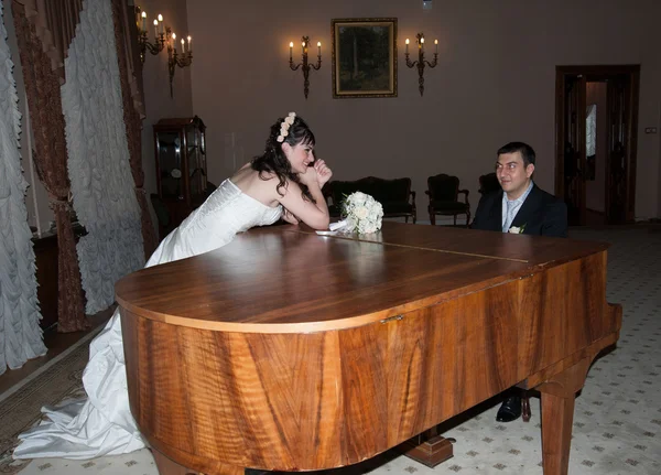 Bride groom plays the piano — Stock Photo, Image