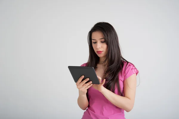 Beautiful woman is pleased tablet — Stock Photo, Image