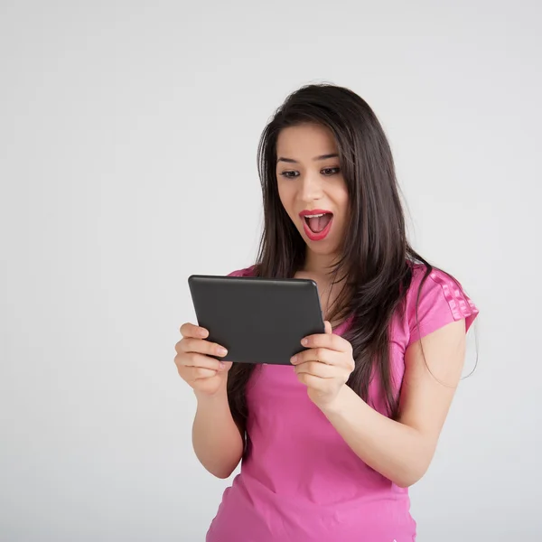 Beautiful woman is pleased tablet — Stock Photo, Image