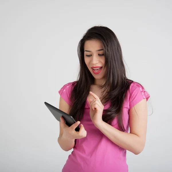 Beautiful woman is pleased tablet — Stock Photo, Image