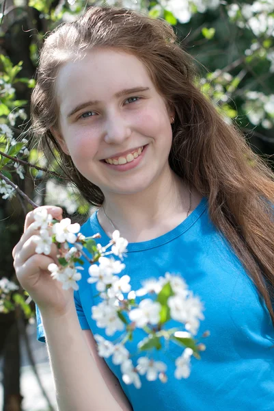 Girl holding a blossoming apple tree — Stock Photo, Image