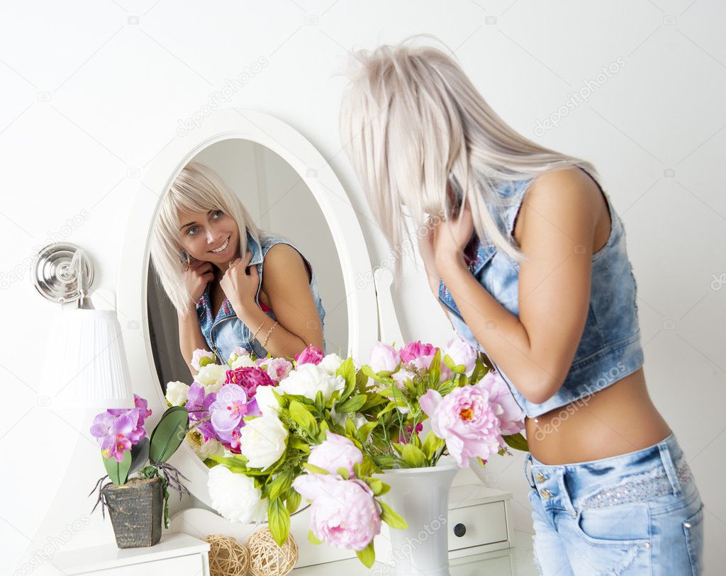 .woman looks in the mirror
