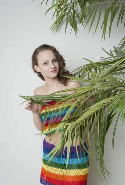 Girl under a palm leaves — Stock Photo, Image