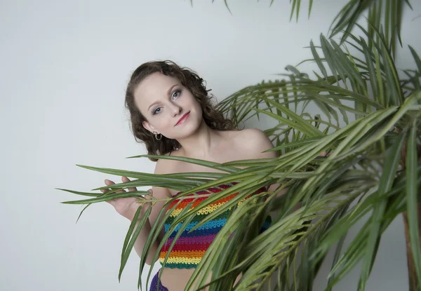 Girl under a palm leaves — Stock Photo, Image