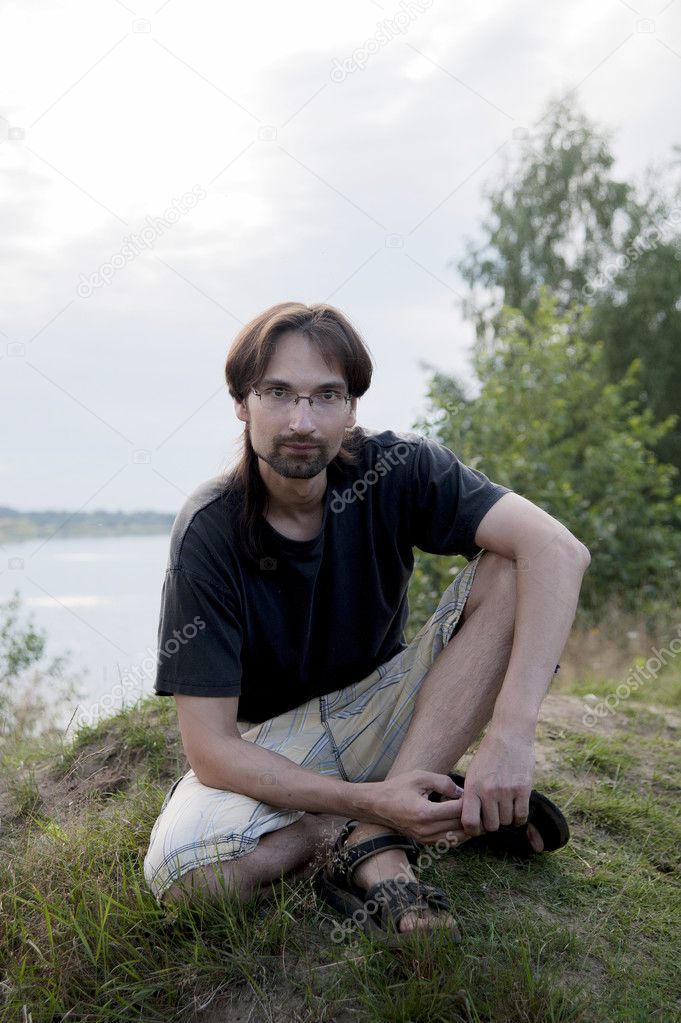 man on the shore of lake