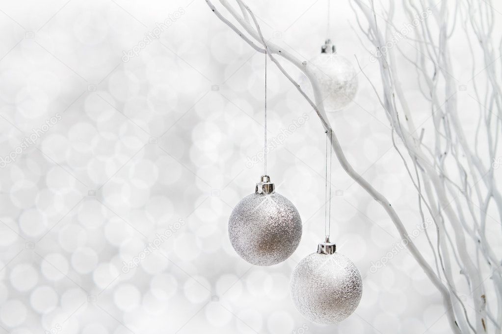 Silver christmas balls on sparkly background