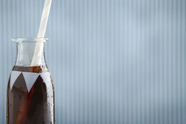 Cute retro soda bottle with cola and straw and background — Stock Photo, Image