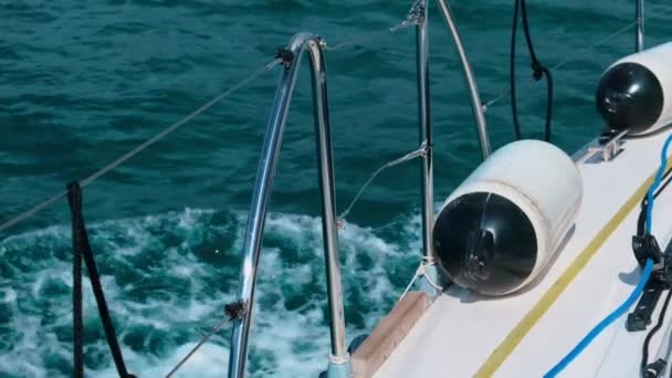 Safety tools on fast yacht sailing blue sea and foamy waves — Stock Video