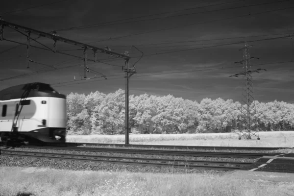 Infrared photo of a train and rails — Stock Photo, Image