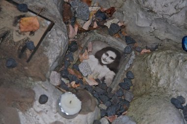 Auschwitz, Poland - November 8, 2008: photo of Anne Frank at the children's memorial at the Jewish cemetery in Warsaw, Poland. clipart