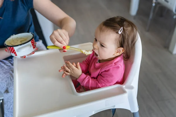 Ein Kleines Kaukasisches Mädchen Sitzt Hochstuhl Während Ihre Mutter Einen — Stockfoto