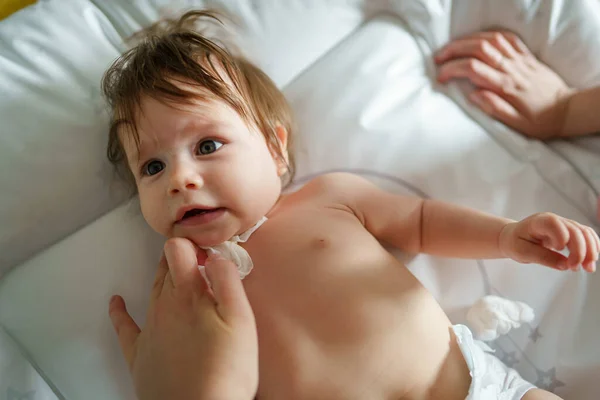 One Small Caucasian Baby Lying Bed Naked Hands Unknown Woman — Stock Photo, Image