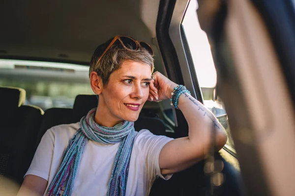 One Mature Woman Caucasian Female Sitting Back Seat Car Looking — Stockfoto