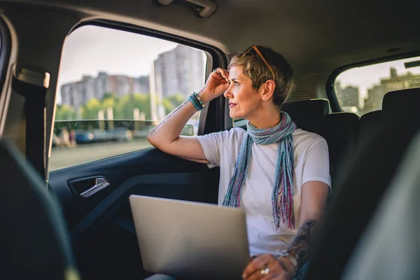 One Mature Woman Caucasian Female Sitting Back Seat Car Thinking — ストック写真