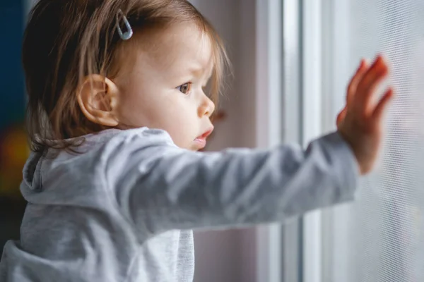 One Small Caucasian Baby Girl Standing Window Home Looking Alone — Stock Photo, Image