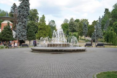 Vrnjacka Banja, Serbia - 08. 03. 2022: Fountain in a park spraying water with tourists in summertime