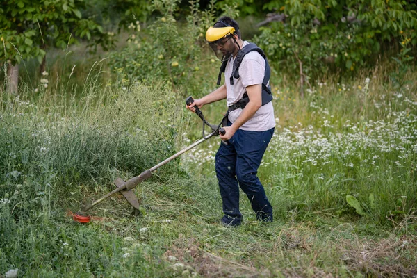 Young Caucasian Man Farmer Gardener Standing Field String Trimmer Petrol — Stok Foto
